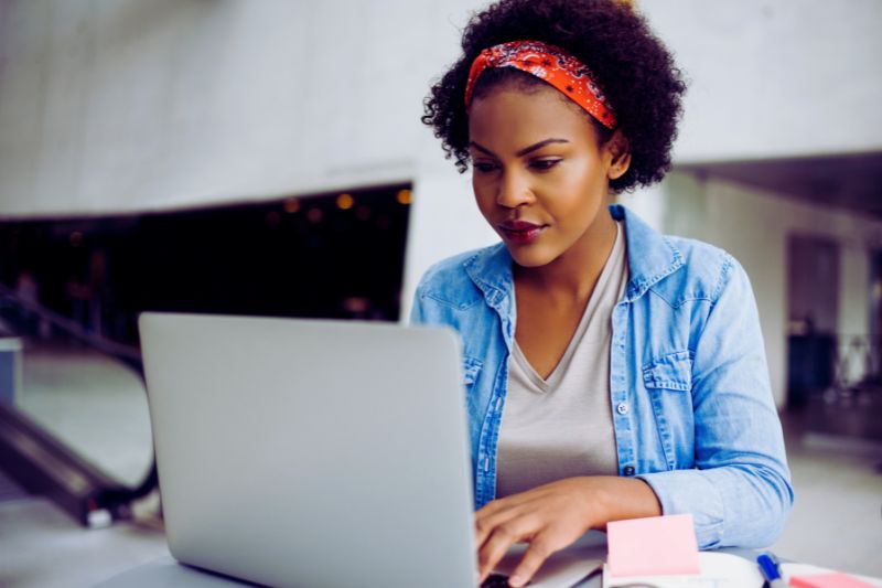 female sitting on a laptop
